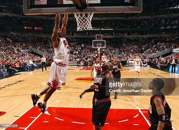 Ben Gordon of the Chicago Bulls slams the ball in front of Marc Jackson and Allen Iverson of the Philadelphia 76ers on January 12, 2005 at the United...