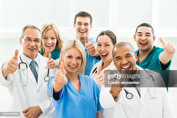 doctors showing thumbs up. - thumbs up stockfoto's en -beelden