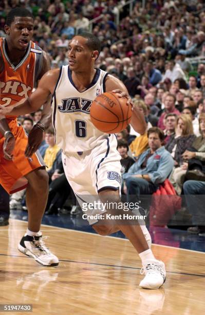 Howard Eisley of the Utah Jazz drives around Joe Johnson of the Phoenix Suns on January 12, 2005 at the Delta Center in Salt Lake City, Utah. NOTE TO...