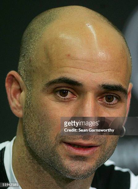 Andre Agassi of the U.S. Addresses the news media after retiring with a hip injury during his game against Andy Roddick of the U.S. During day two of...