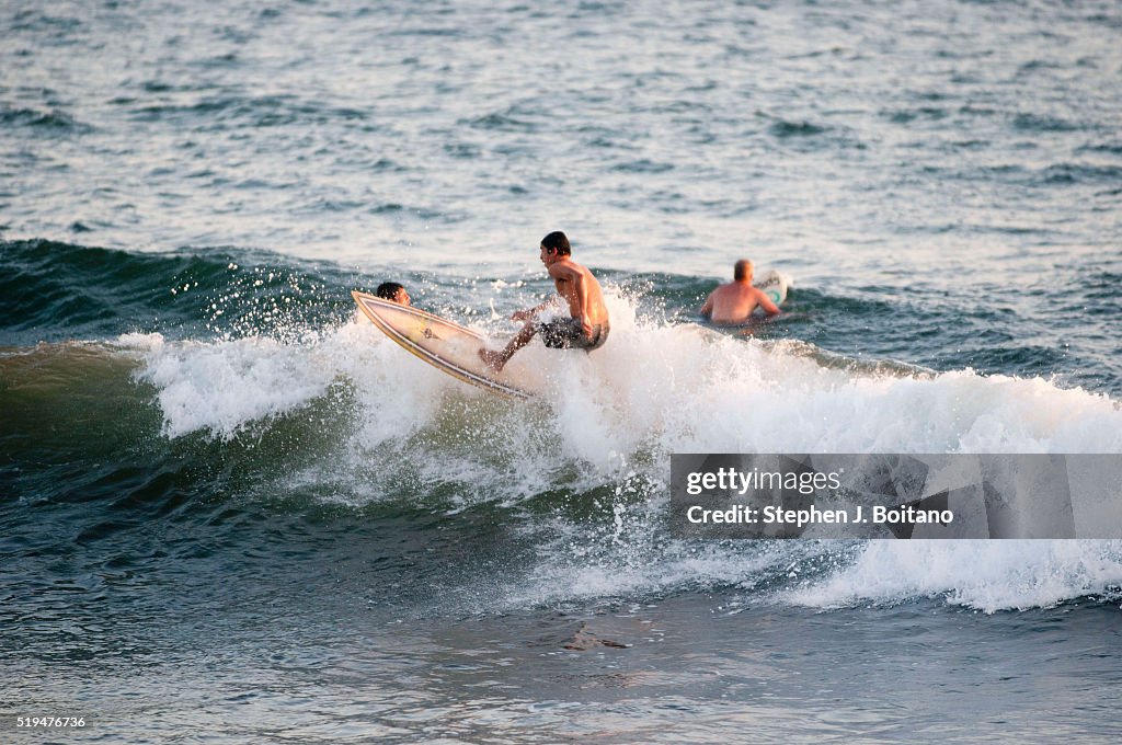 Children surf the waves in El Tunco. El Tunco is now the...