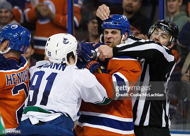 Adam Pardy of the Edmonton Oilers exchanges blows with Jared McCann of the Vancouver Canucks on April 6, 2016 at Rexall Place in Edmonton, Alberta,...