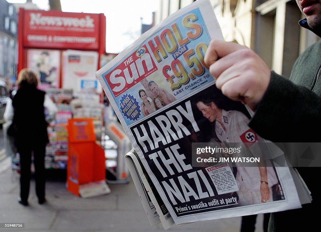 A man reads the newspaper "The Sun" in L