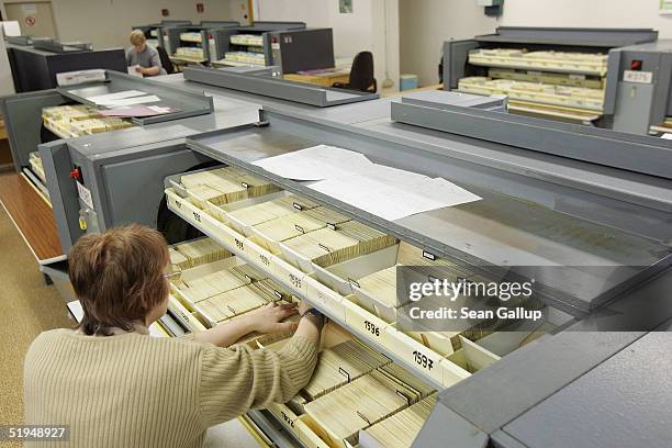 Employees work among the 5.1 milion data cards, each card representing one person, in the massive archives of the former Stasi, the secret police of...