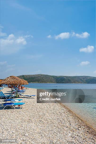 crowded agios dimitrios beach, alonissos - alonissos stock pictures, royalty-free photos & images