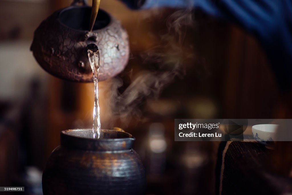 Pouring hot water into a copper jar