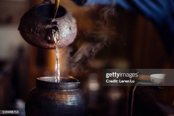 pouring hot water into a copper jar - tea ceremony stock pictures, royalty-free photos & images