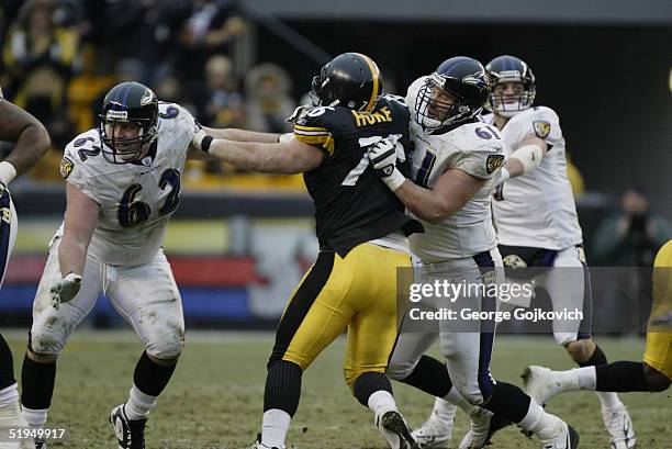 Nose tackle Chris Hoke of the Pittsburgh Steelers is blocked by guard Mike Flynn and center Casey Rabach of the Baltimore Ravens at Heinz Field on...