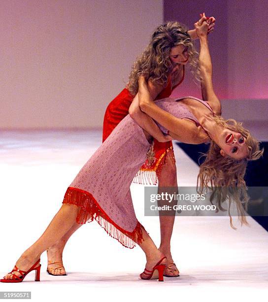 Models dance together in clothes by designer Alannah Hill, at the Australian Fashion Week in Sydney, 10 May 2000. Fox Studios in Sydney is the venue...