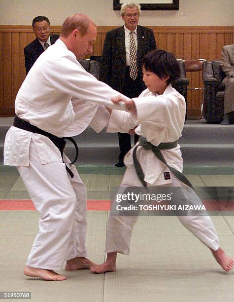 Russian President Vladimir Putin in judo outfit fights against 10-year-old Japanese schoolgirl Natsumi Gomi as he visits a Tokyo judo training center...