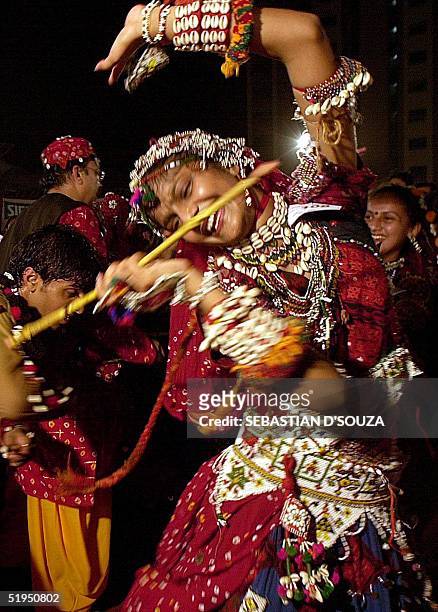 Dandiya damsel dressed in traditional Rajasthani costume dances to the sound of drums on the first night of the Navratri festival late 28 September...