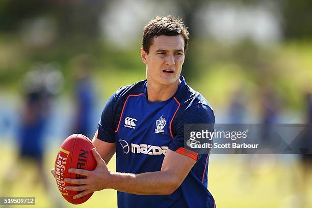 Scott Thompson of the Kangaroos passes the ball during a North Melbourne Kangaroos AFL training session at Arden Street Ground on April 7, 2016 in...