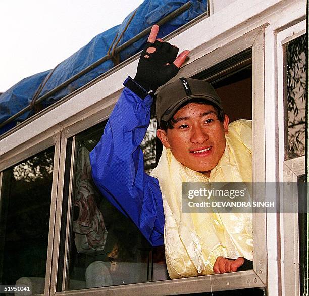 Youngest mountaineer 15-year old Temba Tsheri waves to his friends and families on his way to Mont Everest by surface route via Tibet as he departs...