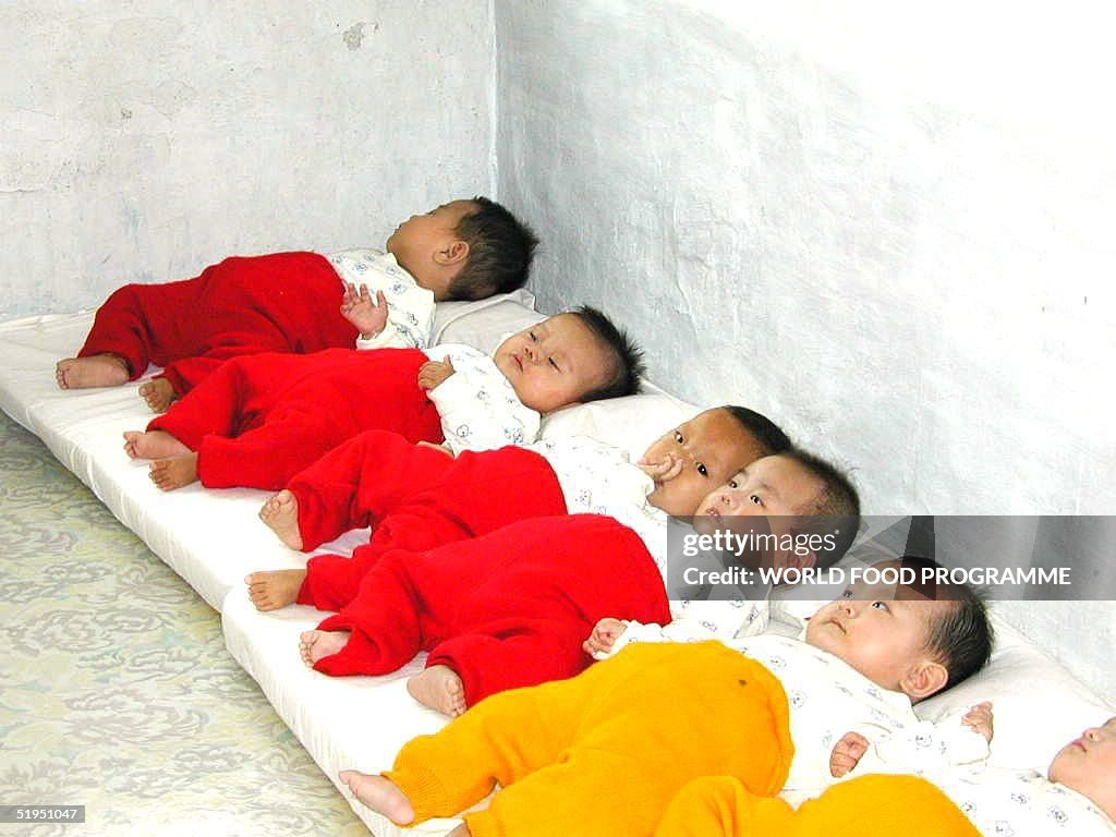 North Korean babies lay on mats at an orphanage, o