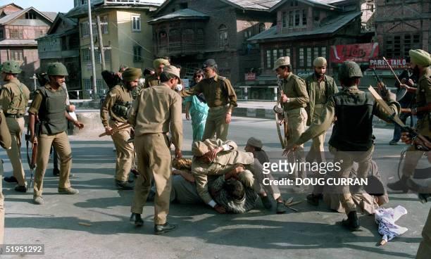 Indian security forces beat Muslim protesters 19 October 1993 during demonstration taken out during the curfew in Srinagar, the summer capital of the...