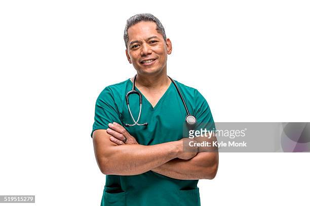 pacific islander nurse standing with arms crossed - mature adult with doctor stock pictures, royalty-free photos & images