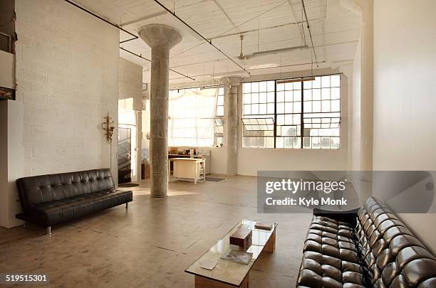 sofas in living room of loft - creative space stock pictures, royalty-free photos & images