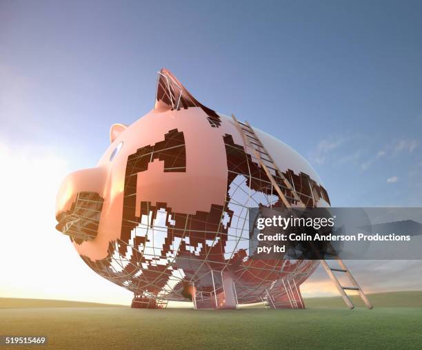 ladder leaning on large piggy bank under construction - undone stock pictures, royalty-free photos & images