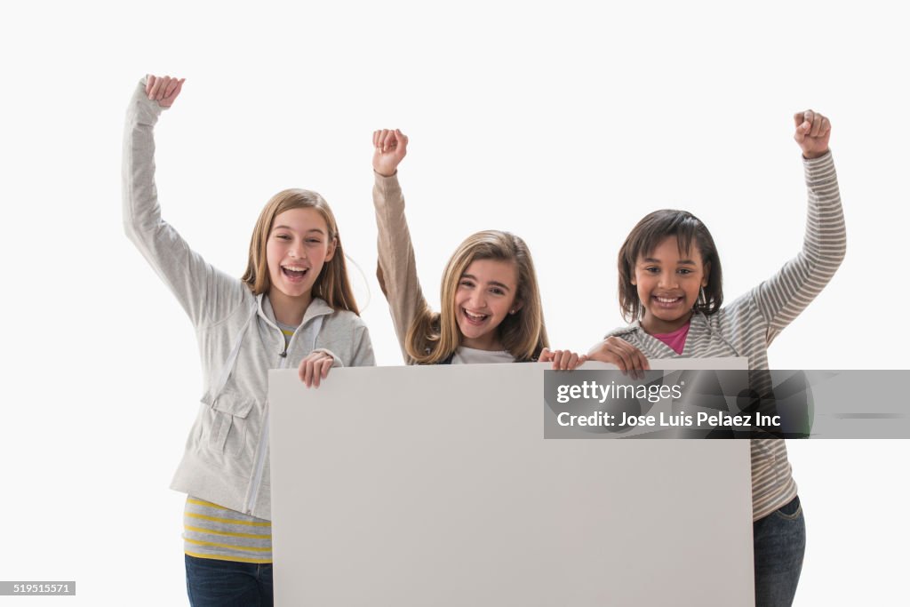 Cheering girls holding blank card