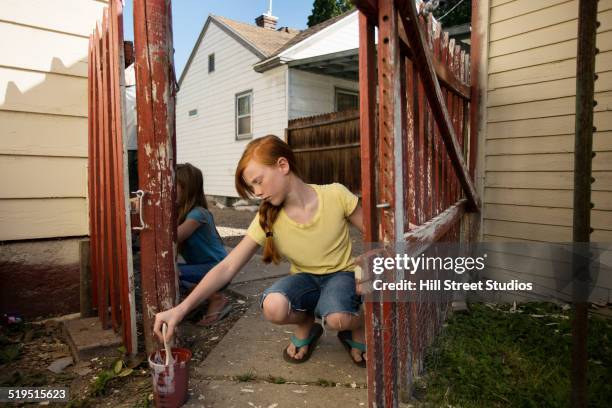 caucasian girl painting fence - white picket gate stock pictures, royalty-free photos & images