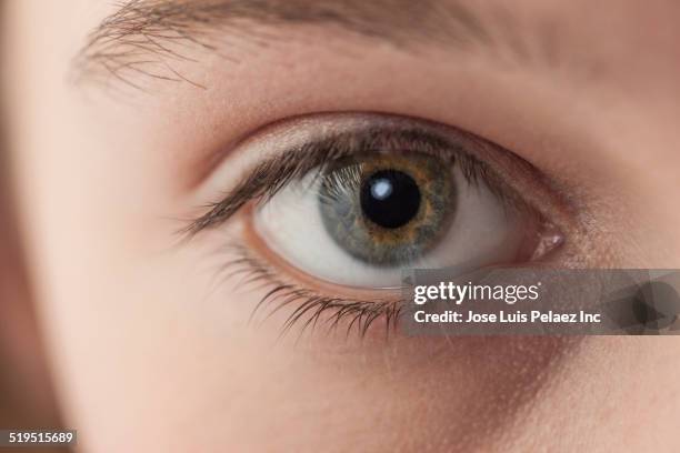 close up of eye of caucasian girl - iride foto e immagini stock