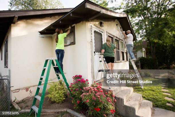people painting house - community health centre stock pictures, royalty-free photos & images