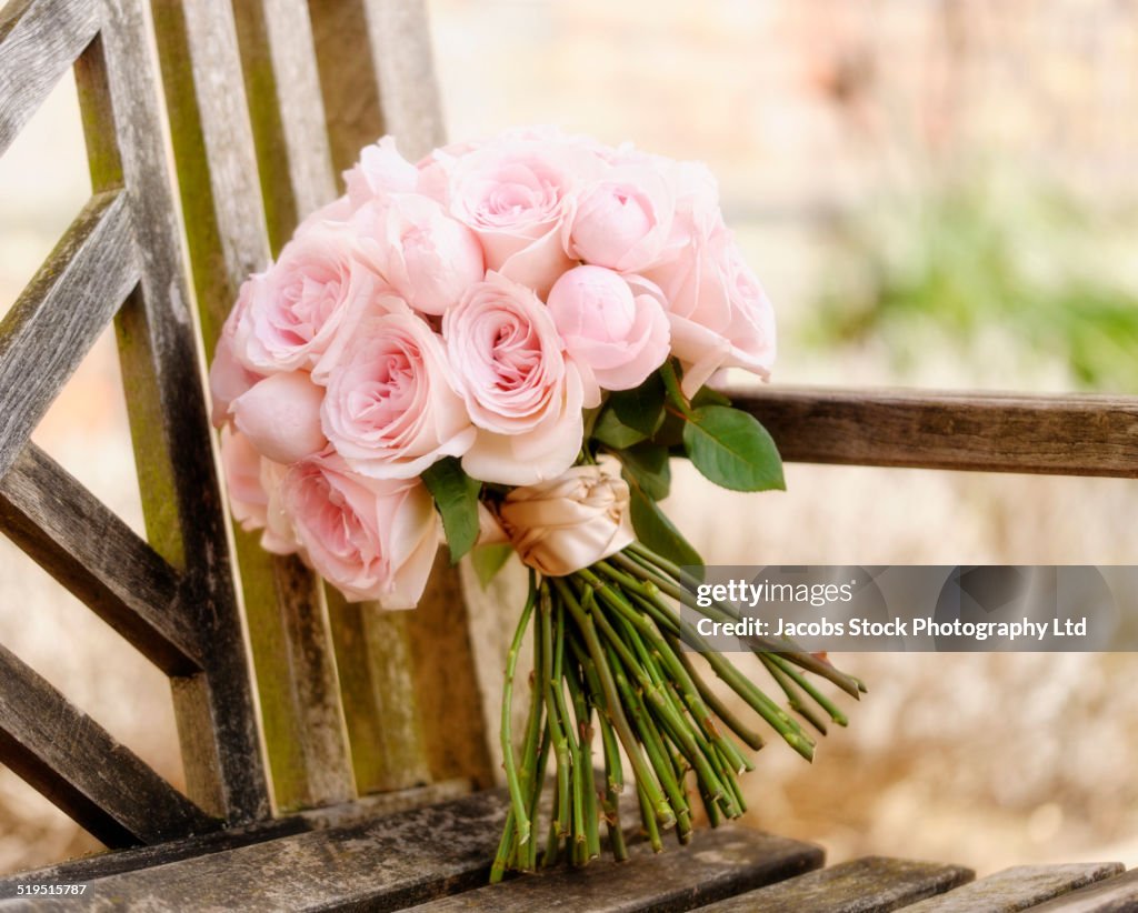 Close up of bouquet of roses on wooden bench