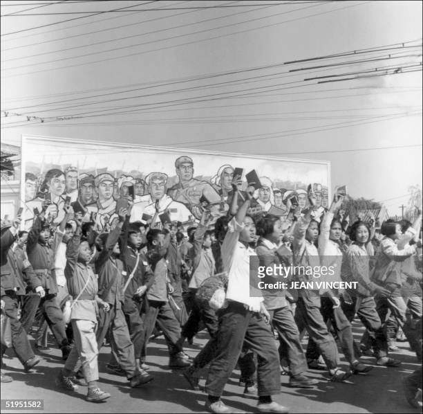 Red Guards, high school and university students, waving copies of Chairman Mao Zedong's "Little Red Book," parade in June 1966 in Beijing's streets...