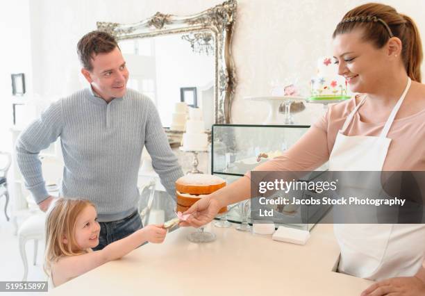 girl with father paying baker in bakery - serving hatch stock pictures, royalty-free photos & images