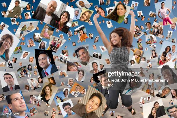 businesswoman jumping for joy in images of faces floating in sky - crowd looking into camera happy indian stock-fotos und bilder