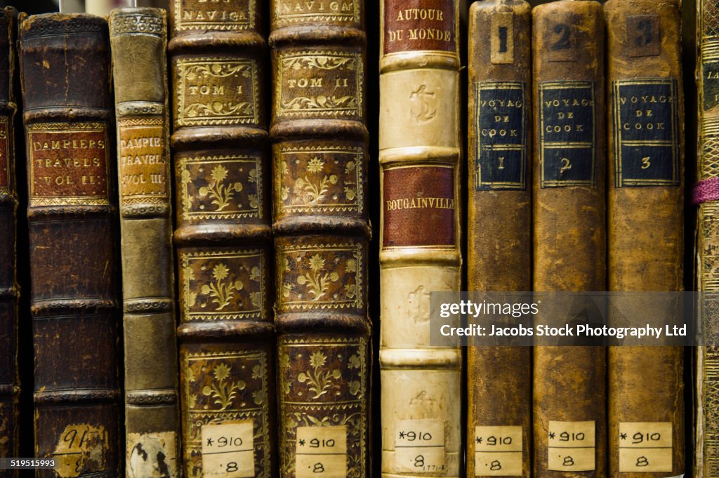 Close up of old leather bound books in library