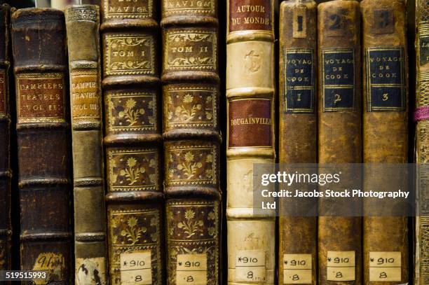 close up of old leather bound books in library - history of magic exhibition launch stockfoto's en -beelden