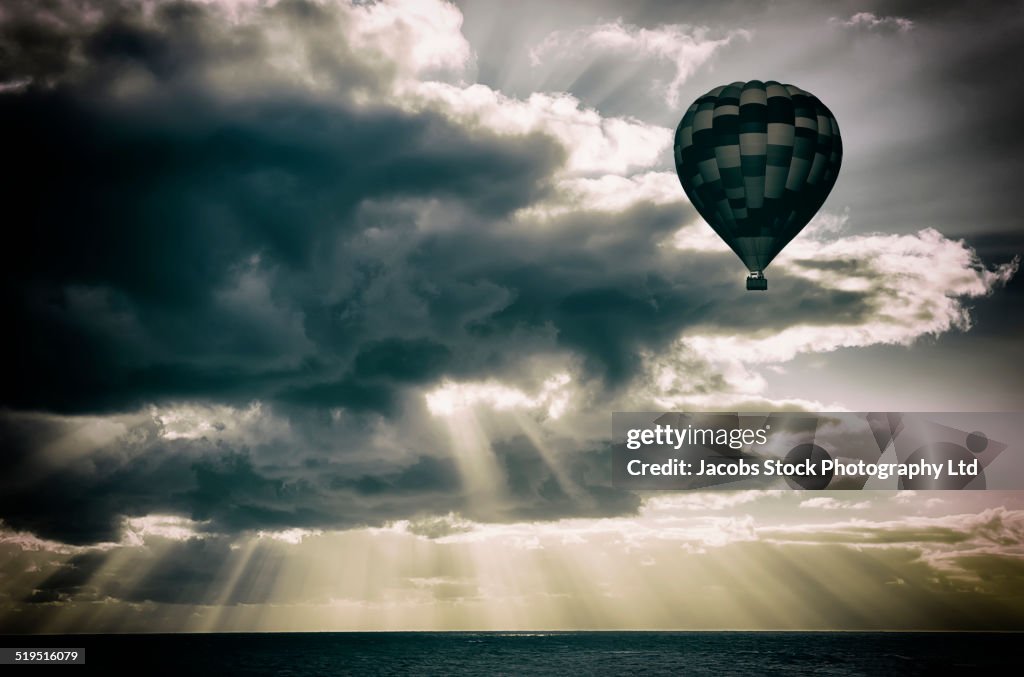 Hot air balloon floating in sunbeams