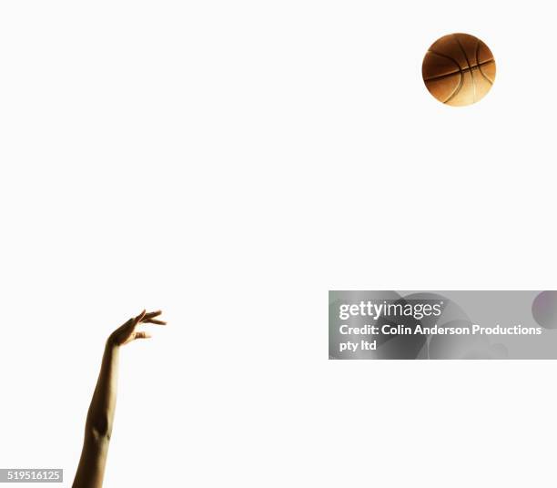 arm of black basketball player shooting ball - bras homme fond blanc photos et images de collection