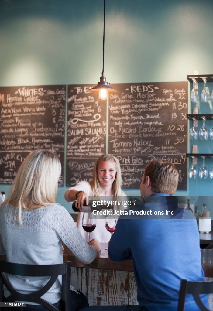 Caucasian couple drinking wine at wine bar