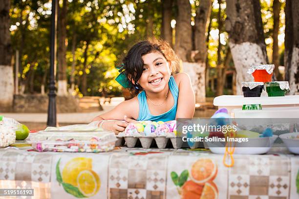 hispanic girl smiling with easter eggs - mexican picnic stock pictures, royalty-free photos & images