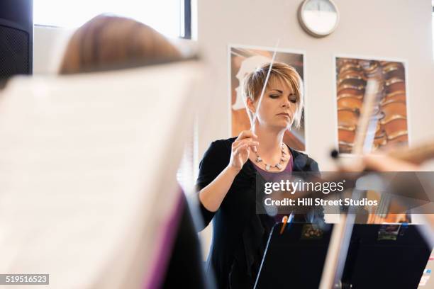 caucasian teacher conducting music class - maestro stock pictures, royalty-free photos & images