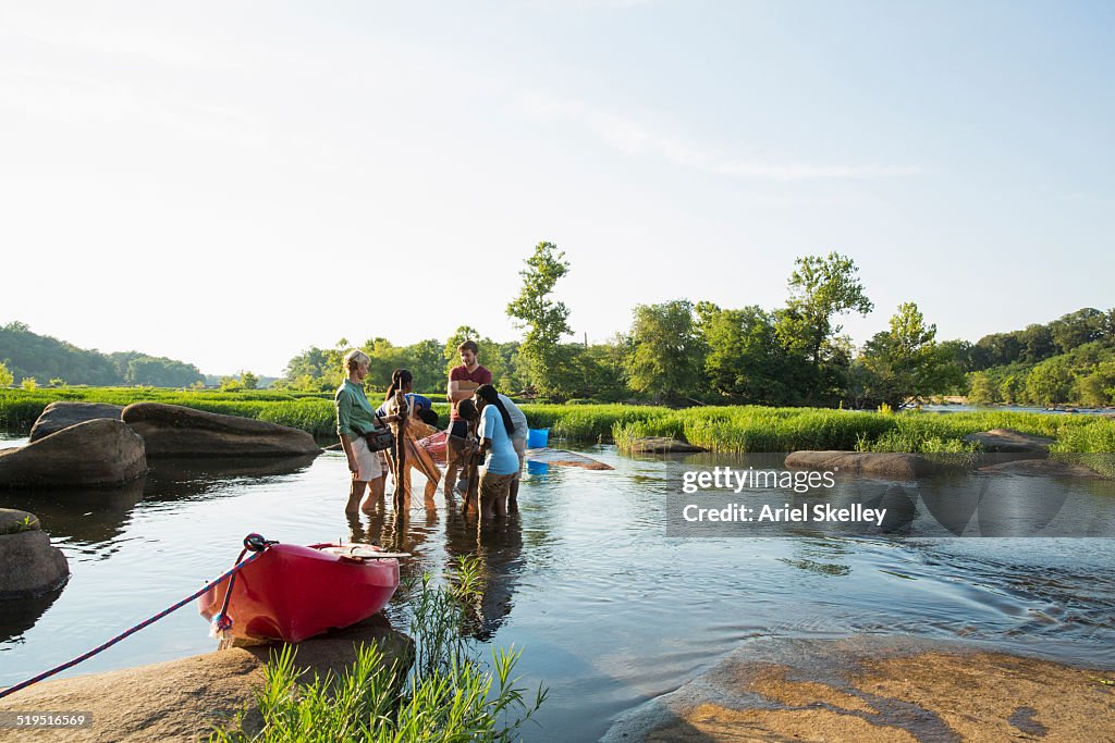 Volunteers working together in river