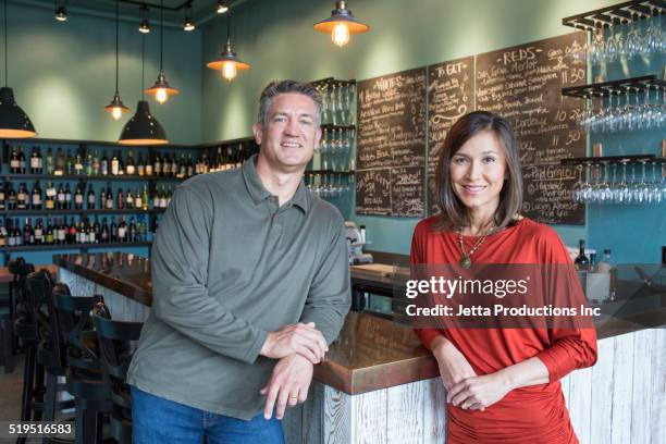 business partners smiling in wine bar - corner shop stock-fotos und bilder