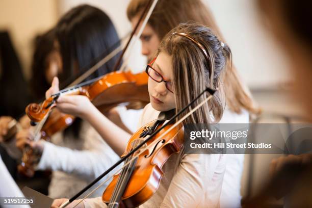 caucasian girl playing violin in music class - differential focus education stock pictures, royalty-free photos & images