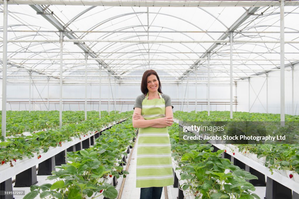 Caucasian woman standing in greenhouse