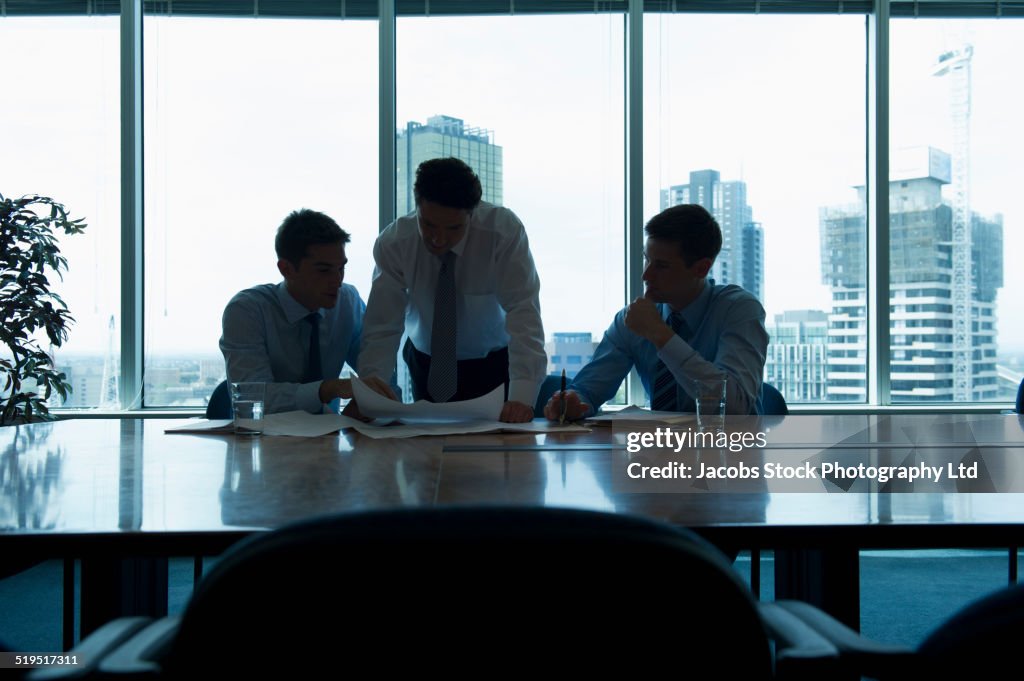 Businessmen talking in office meeting