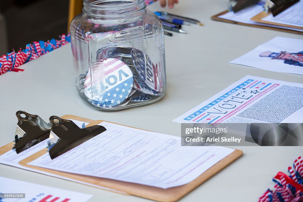 Clipboards and buttons at voter registration table