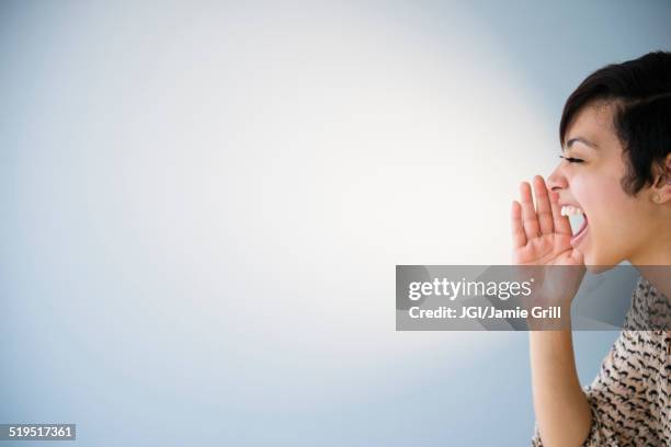 close up of mixed race woman shouting - shouting happy stock pictures, royalty-free photos & images