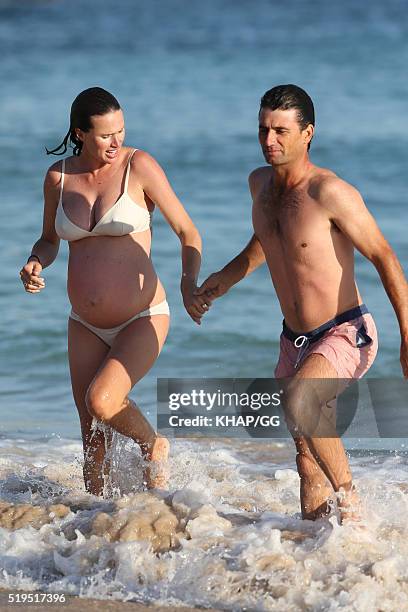 Heavily pregnant Francesca Cumani and husband Rob Archibald enjoy a day at the beach on April 6, 2016 in Sydney, Australia.