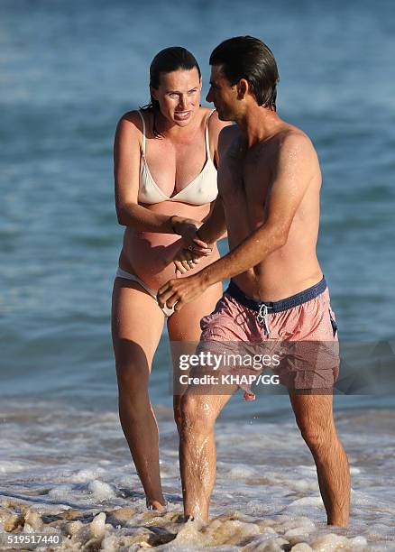 Heavily pregnant Francesca Cumani and husband Rob Archibald enjoy a day at the beach on April 6, 2016 in Sydney, Australia.