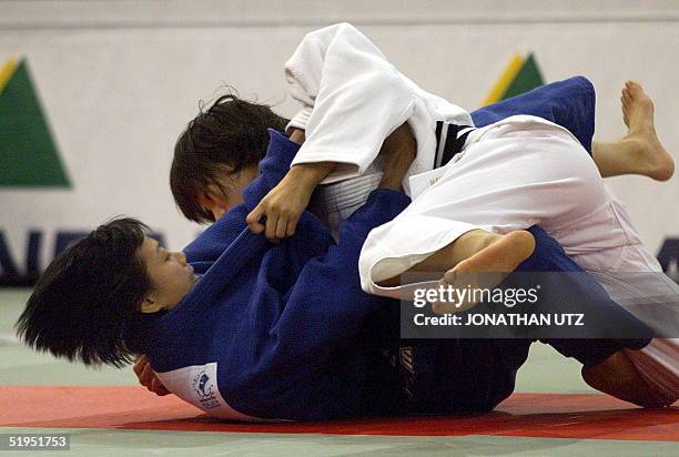 Noriko Narasaki of Japan gets Hong Kong's Chan Mei Ling to the mat during their first round fight in the under-52kg category at the 26th Judo World...
