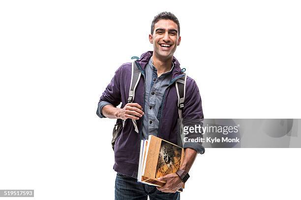 indian student carrying books and backpack - three quarter length stockfoto's en -beelden