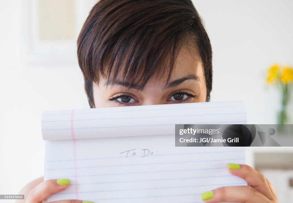 Mixed race woman holding empty to do list