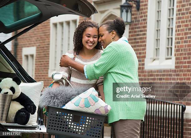 mother and daughter hugging near car - african girl hug stock pictures, royalty-free photos & images